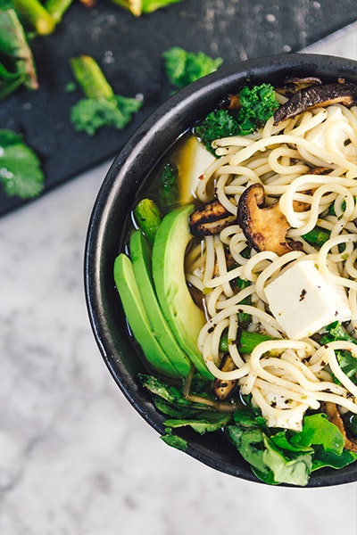 bowl of noodles with vegtables, avocado and tofu