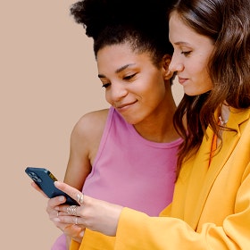 Duas amigas a ver as promoções do NorteShopping no telemóvel